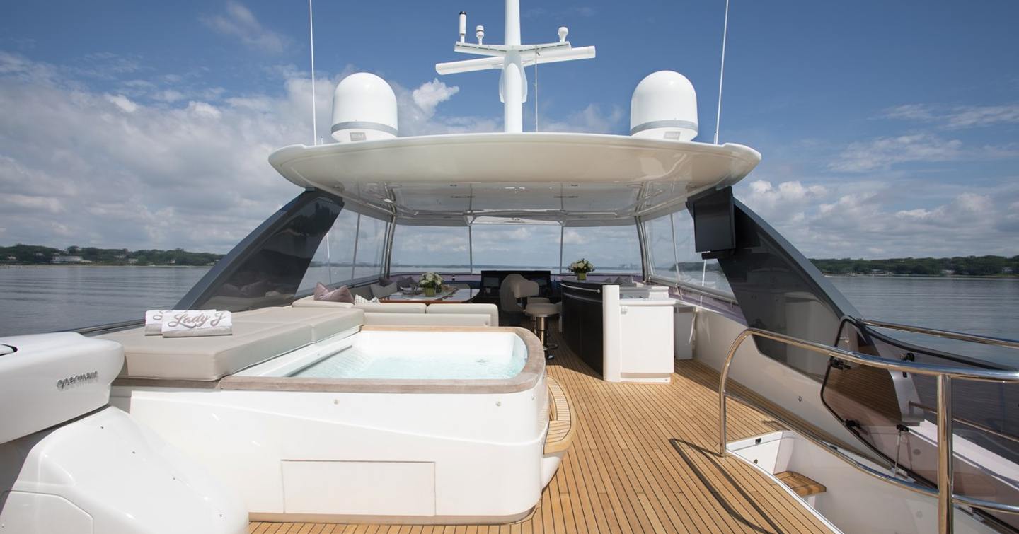Motor yacht Lady J flybridge with jacuzzi and shaded alfresco dining