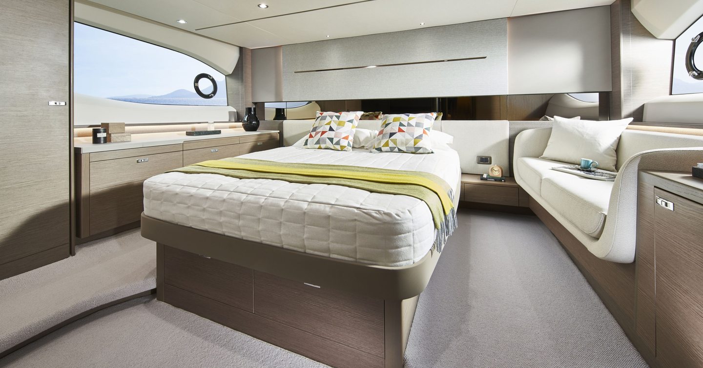 Princess V55 full-beam midships owner’s cabin with double berth, hull window and sofa in 17.81m sportsboat