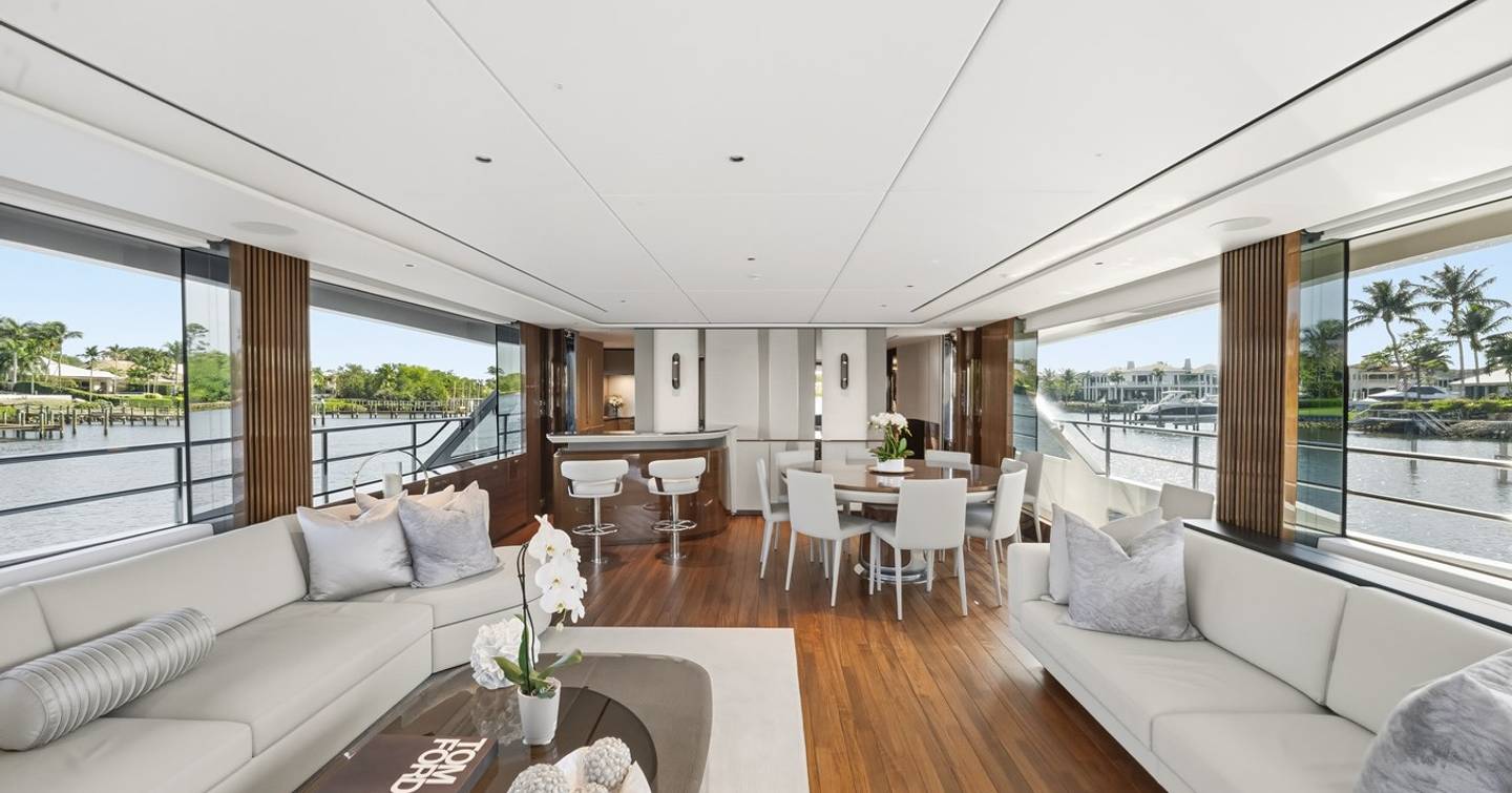Princess Y95 Motor Yacht Just Perfect main salon with white sofa and circular dining area 