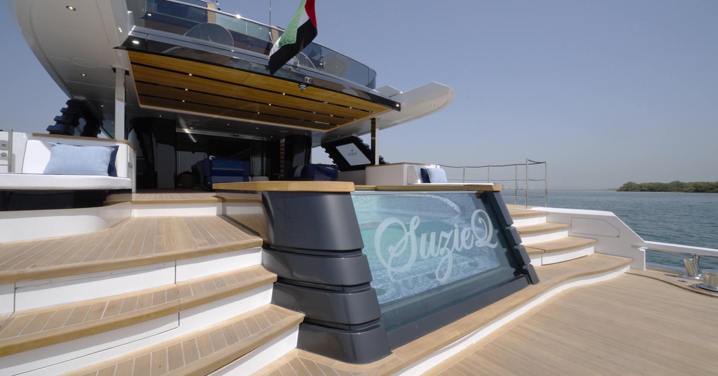 Beach club infinity pool aboard the Gulf Craft Majesty 145 with steps to the swim platform