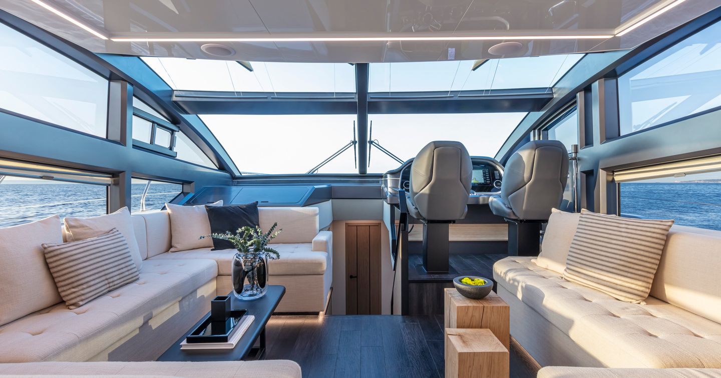 Main salon onboard Pearl 62, facing white sofas with small coffee table and wide windows to both sides