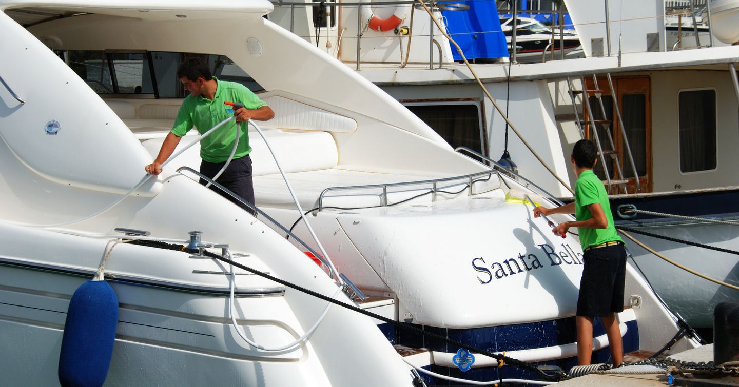 two crew cleaning a yacht