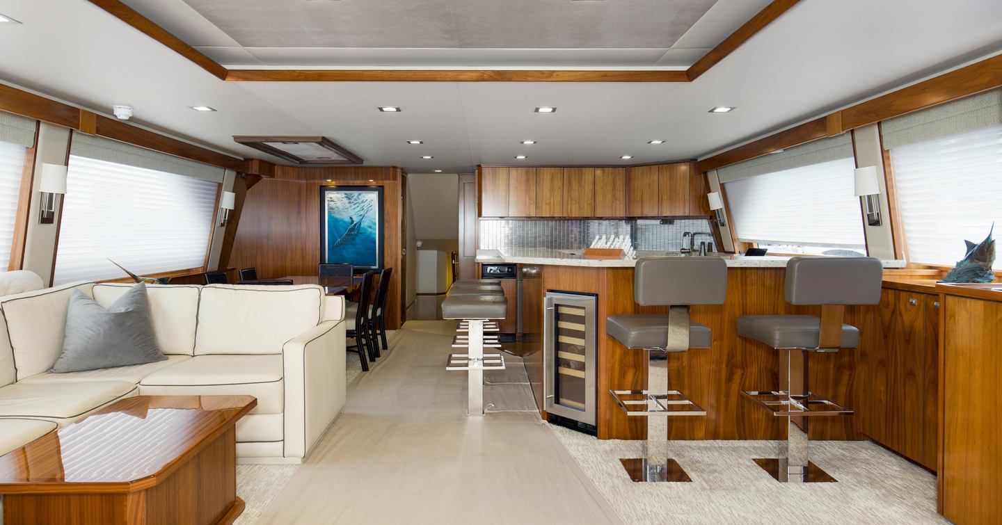 Viking 92EB Sportsfisher yacht Touche main saloon with white sofa and integrated bar with grey stools