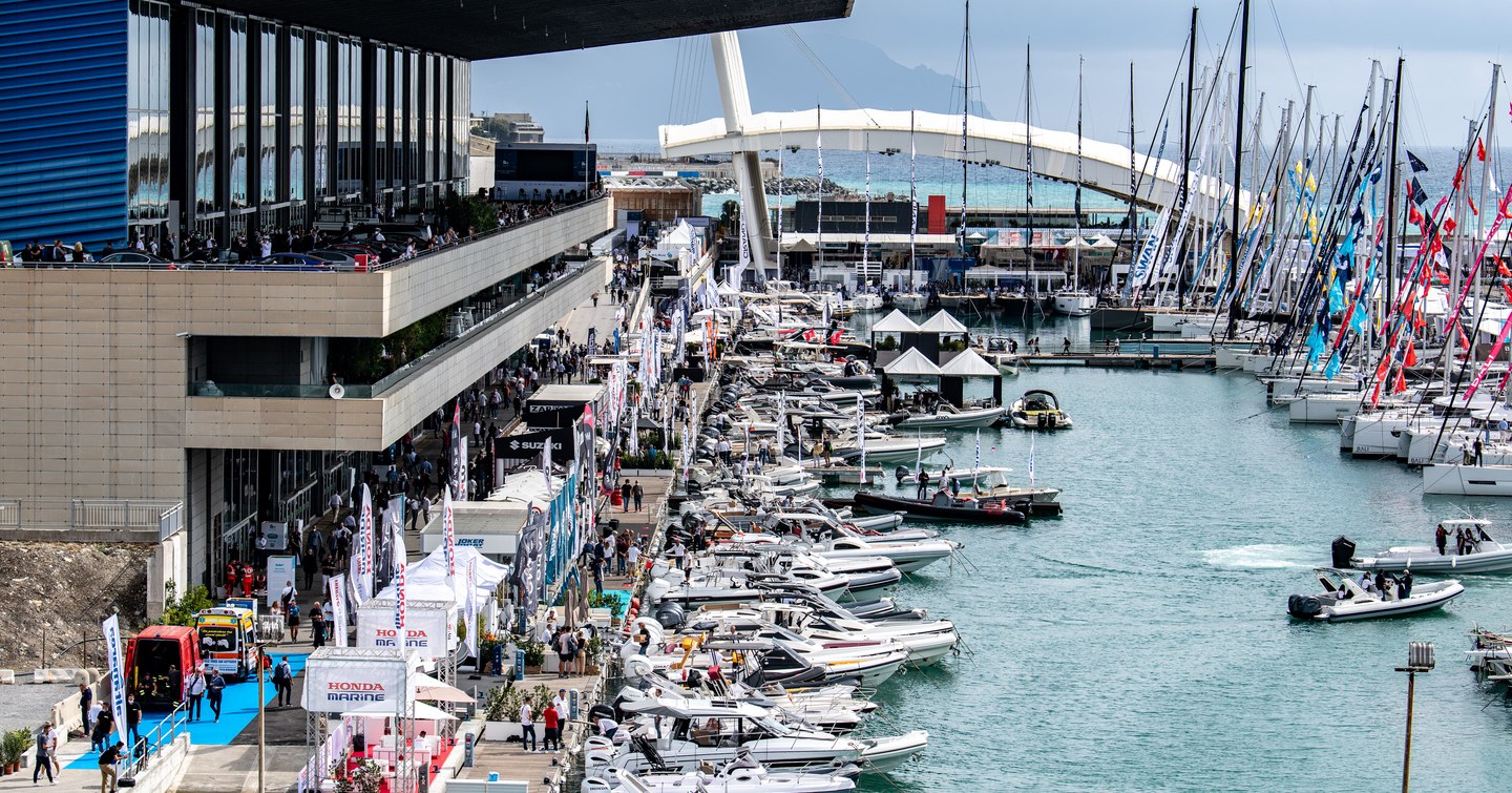 Motor yachts and sailing boats moored at Piazzale John Fitzgerald Kennedy in Genoa during boating event.