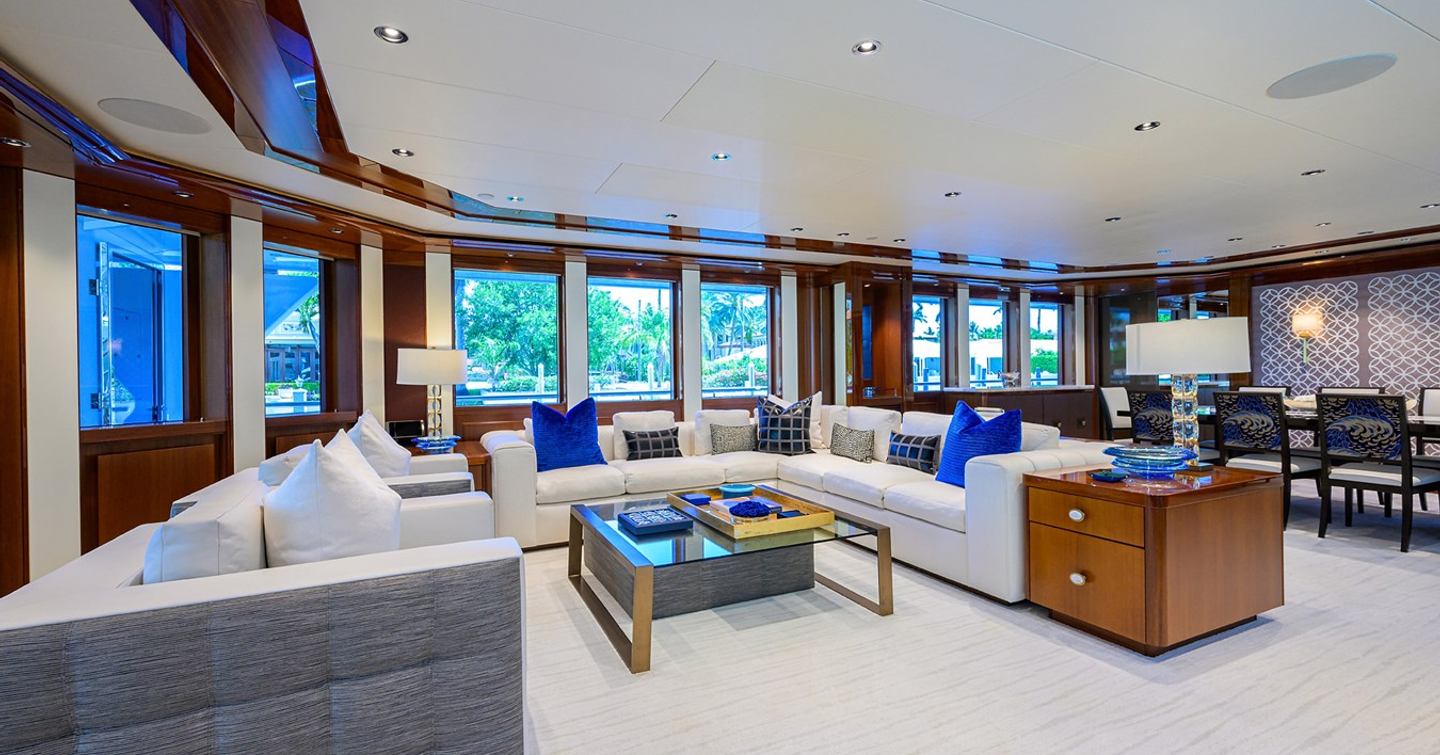 Superyacht Neenah main saloon with L-shaped white sofa