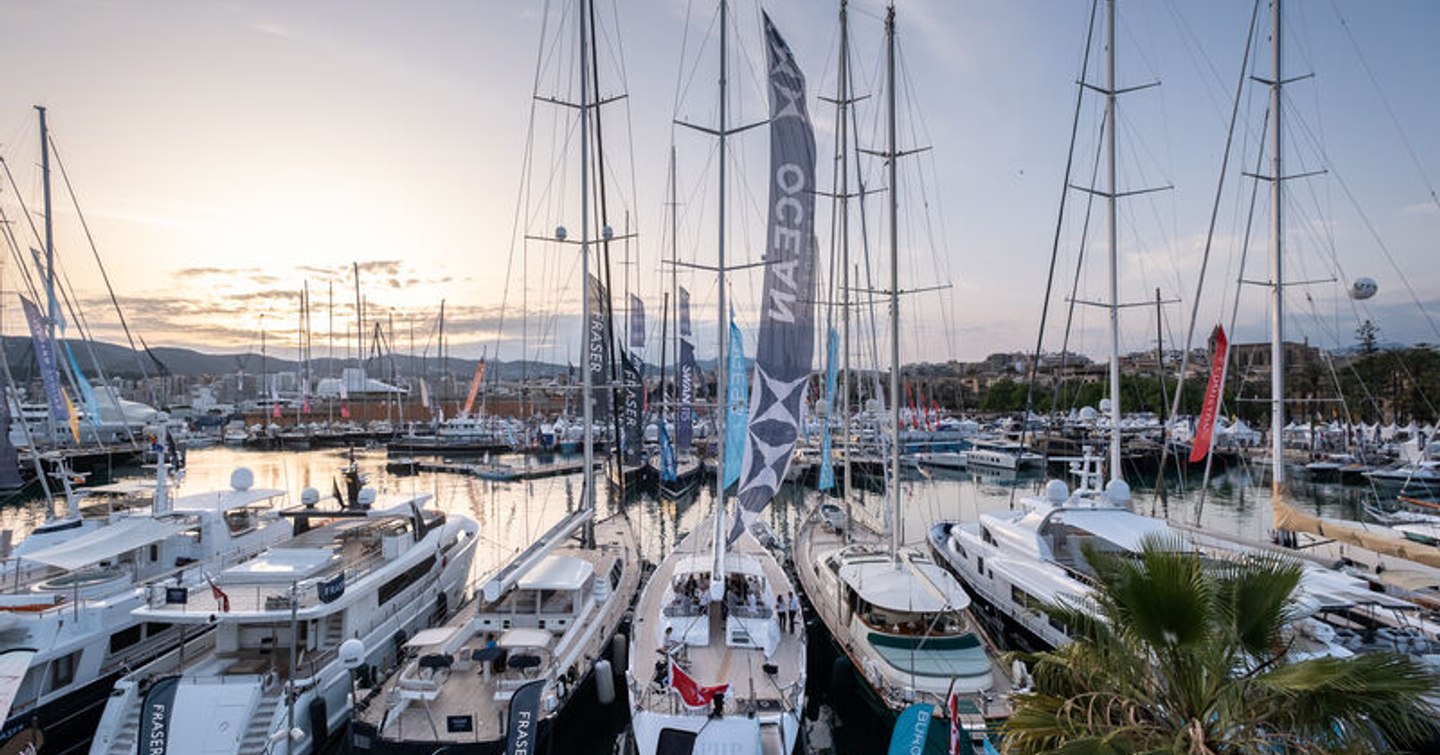 Panning shot looking over the many sailing boats and motor yachts berthed in Marina Moll Vell, Palma.