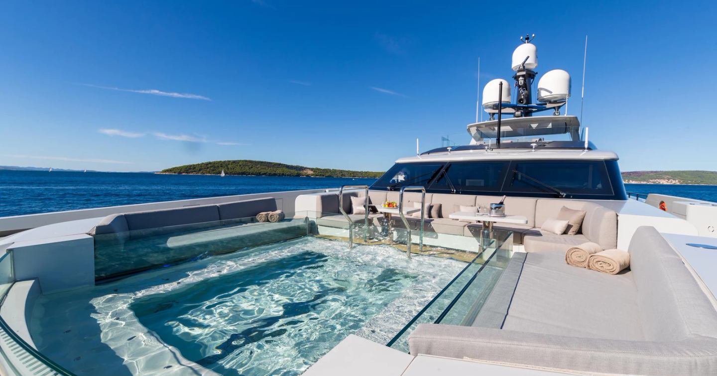 Superyacht Kinda foredeck swimming pool and surrounding sunpads 