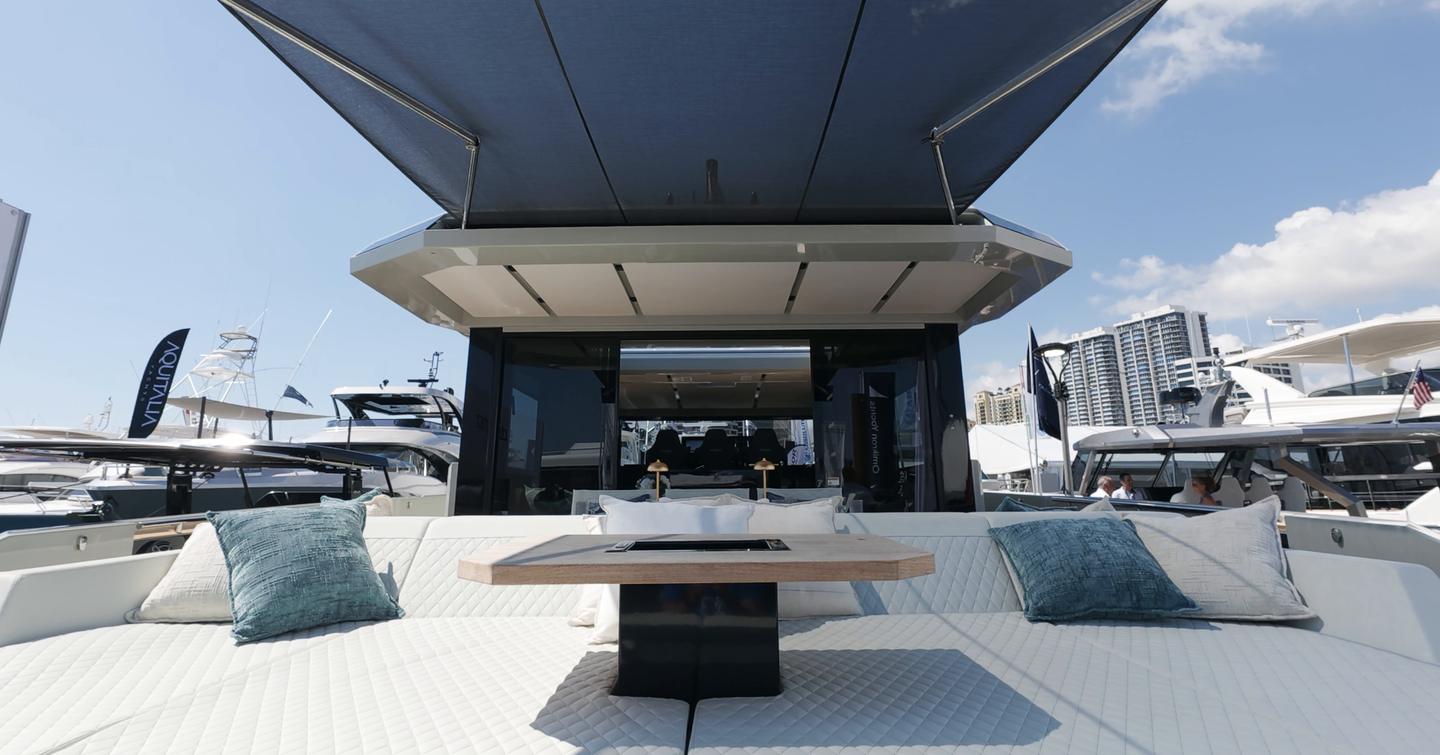 De Antonio D60 aft sun pad and cockpit seating beneath retractable shade canopy