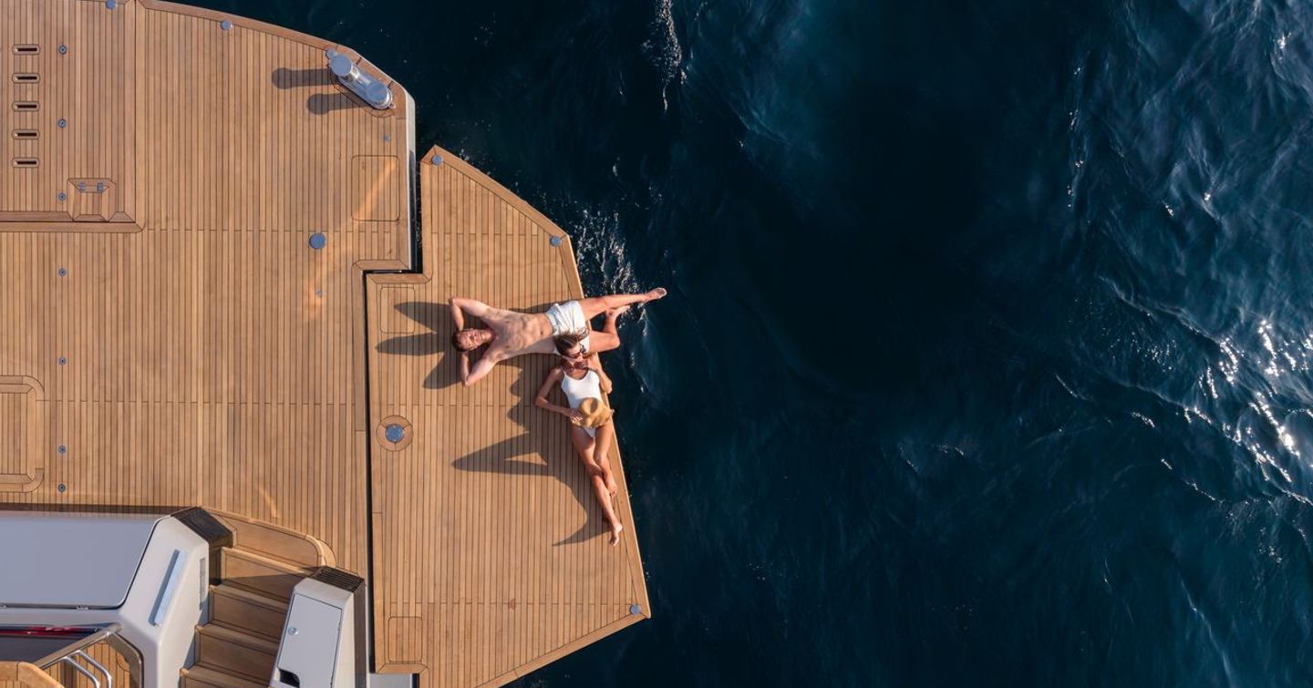 Aerial view of couple on Sirena 118 Superyacht IKIGAI stern