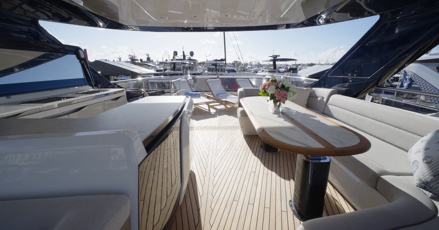 Flybridge dining and lounge area aboard the Galeon 620 Fly with wet bar and aft sun loungers.