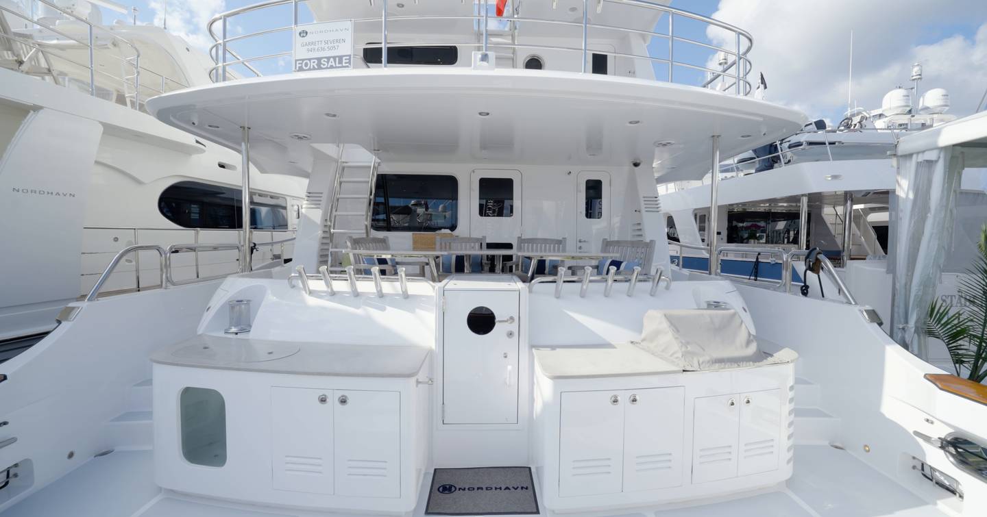 Nordhavn 75 EYF mezzanine deck overlooking the tournament fishing cockpit with outdoor dining area