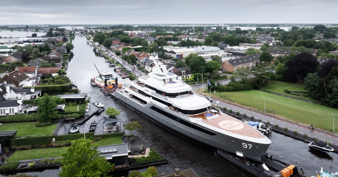 Feadship 80m Explorer Yacht Valor being towed through dutch canals 