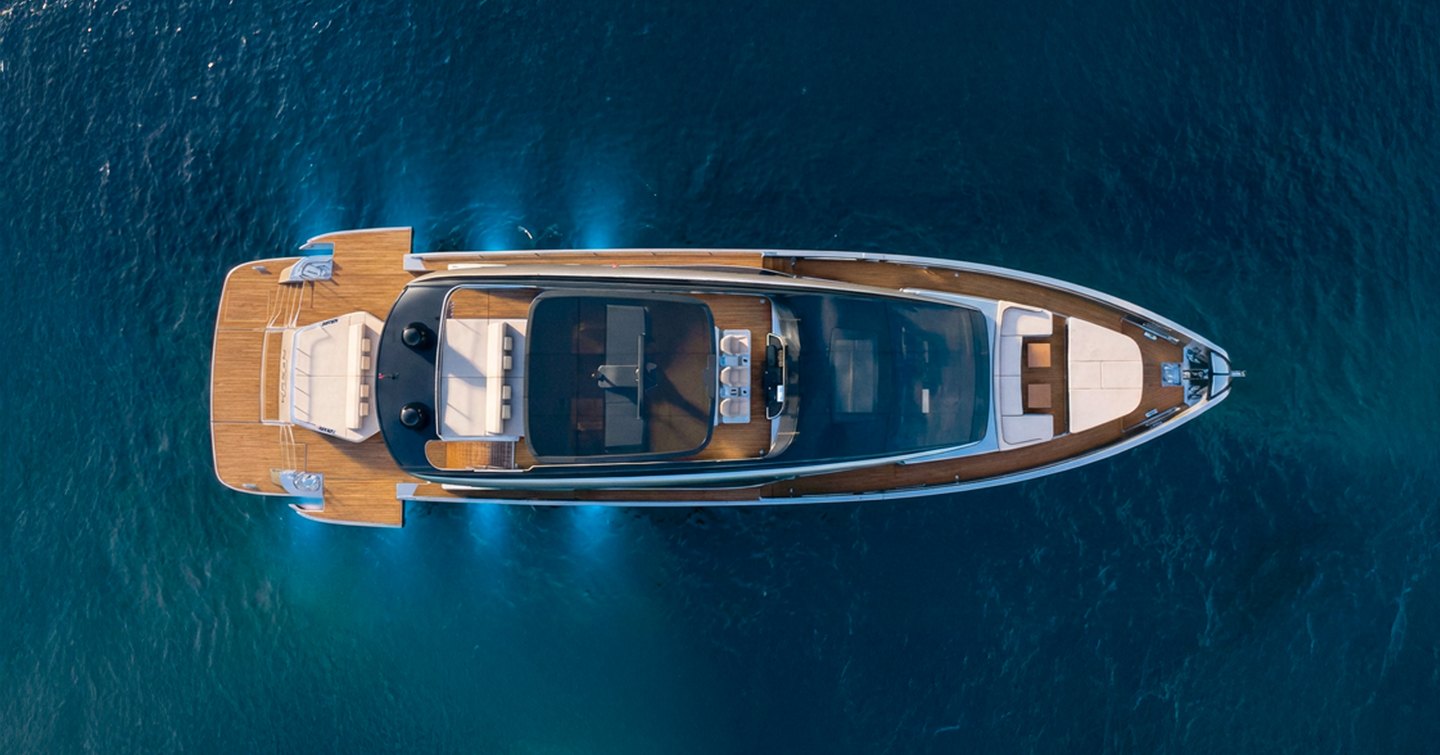 Aerial rendering of Pershing GTX90 motor yacht at anchor with aft underwater lights