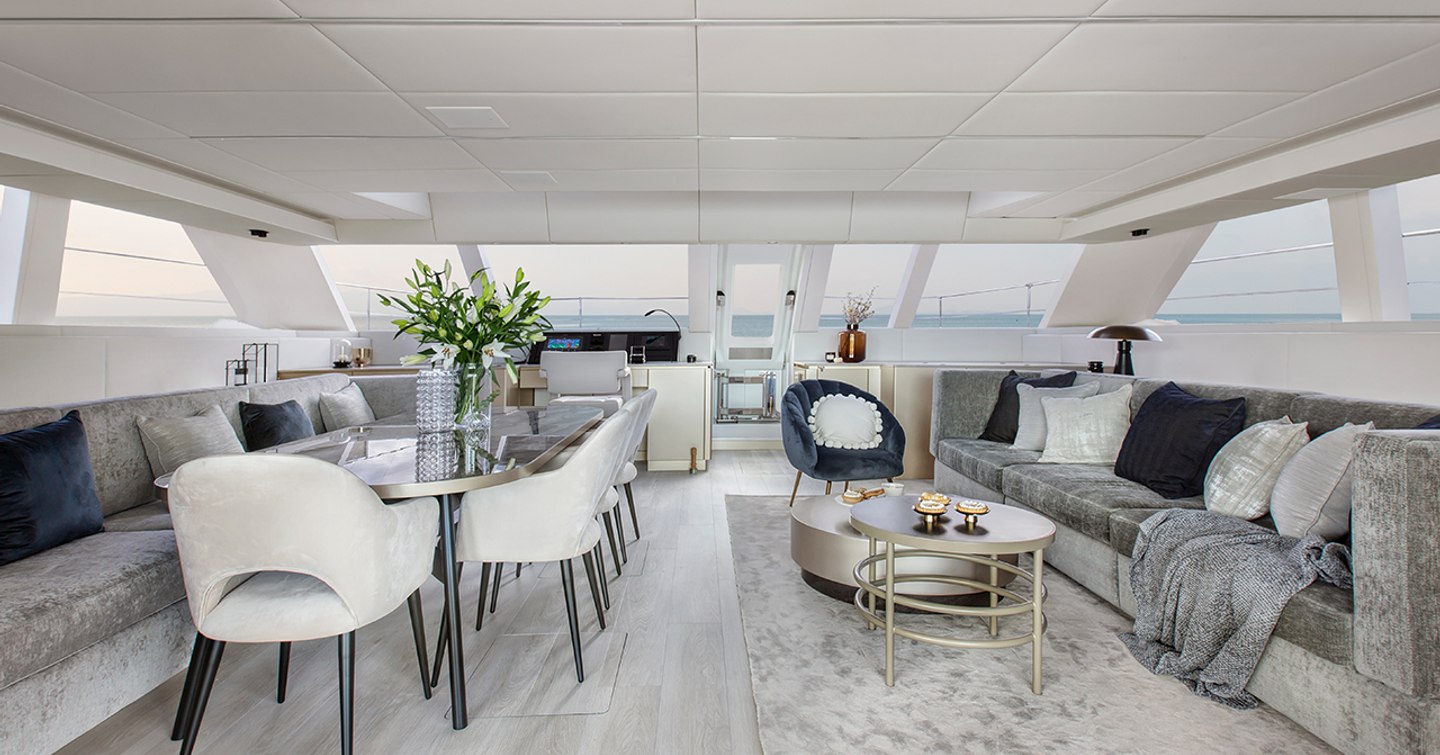 Sunreef Yachts 60 Sunreef Power catamaran main saloon with grey furniture and dining area