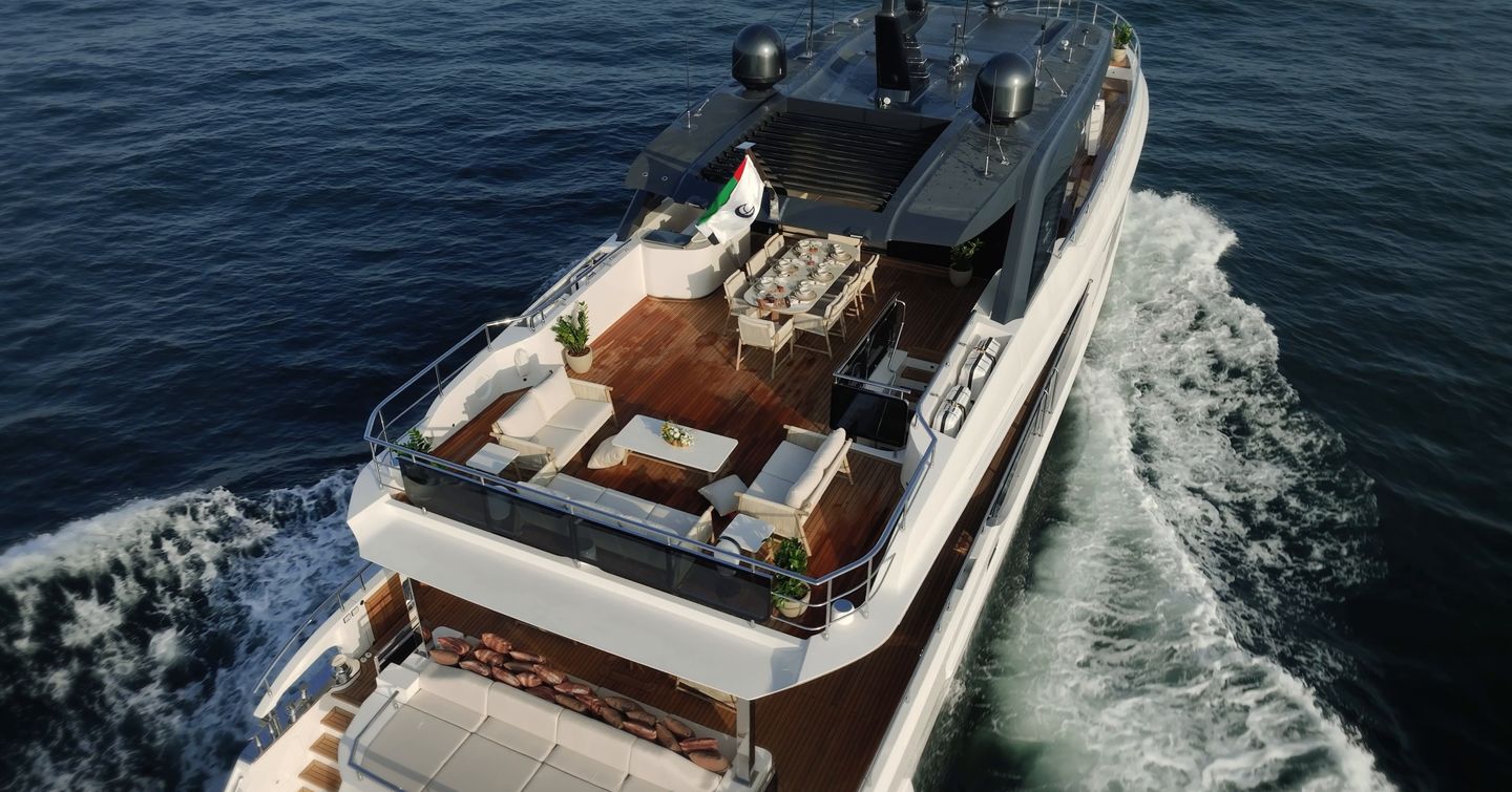 Bridge deck aft aboard the Gulf Craft Majesty 100 Terrace with outdoor dining and lounge seating