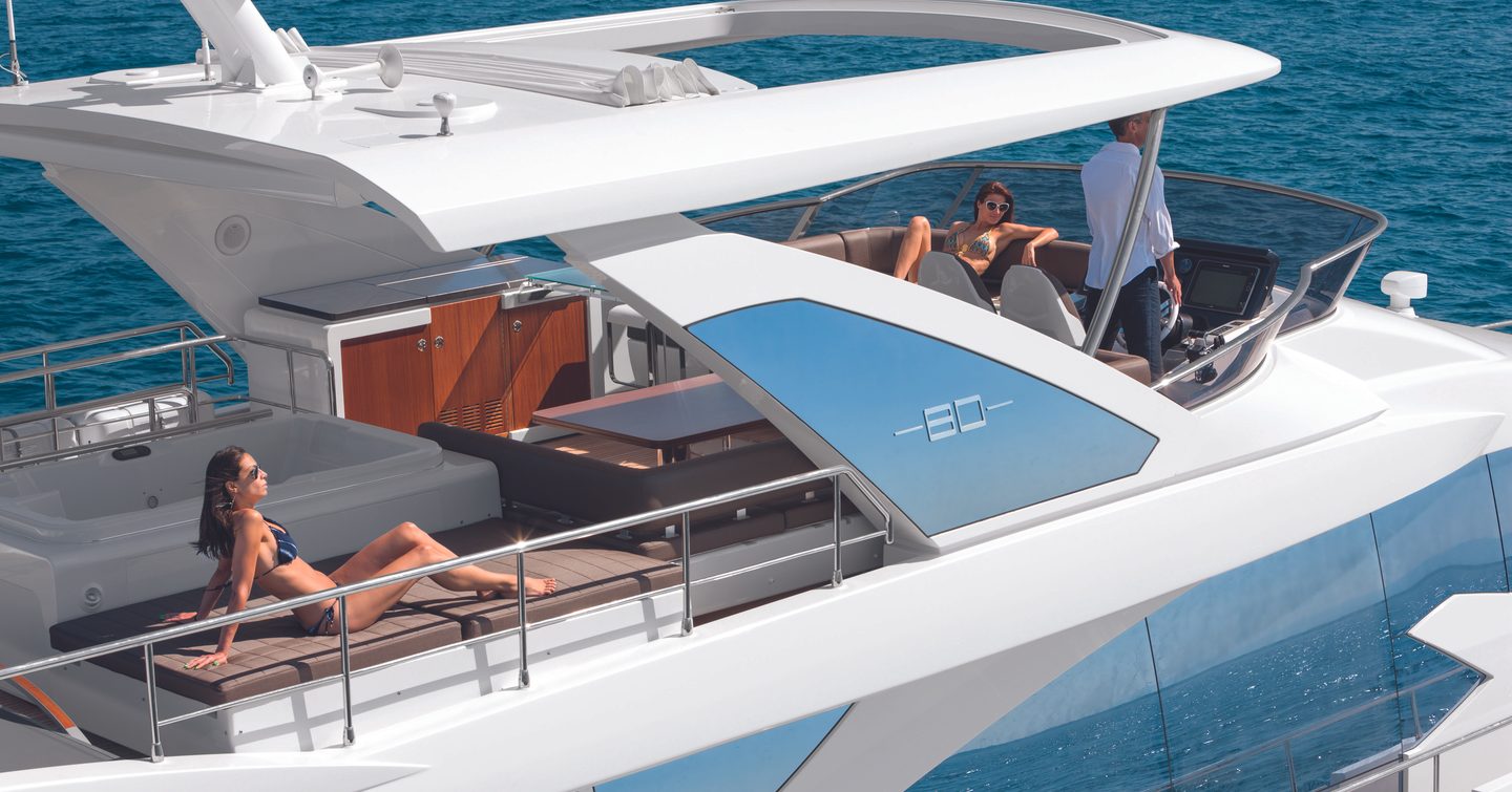 Yacht charter guests relaxing on the flybridge of an 80ft Azimut motor yacht