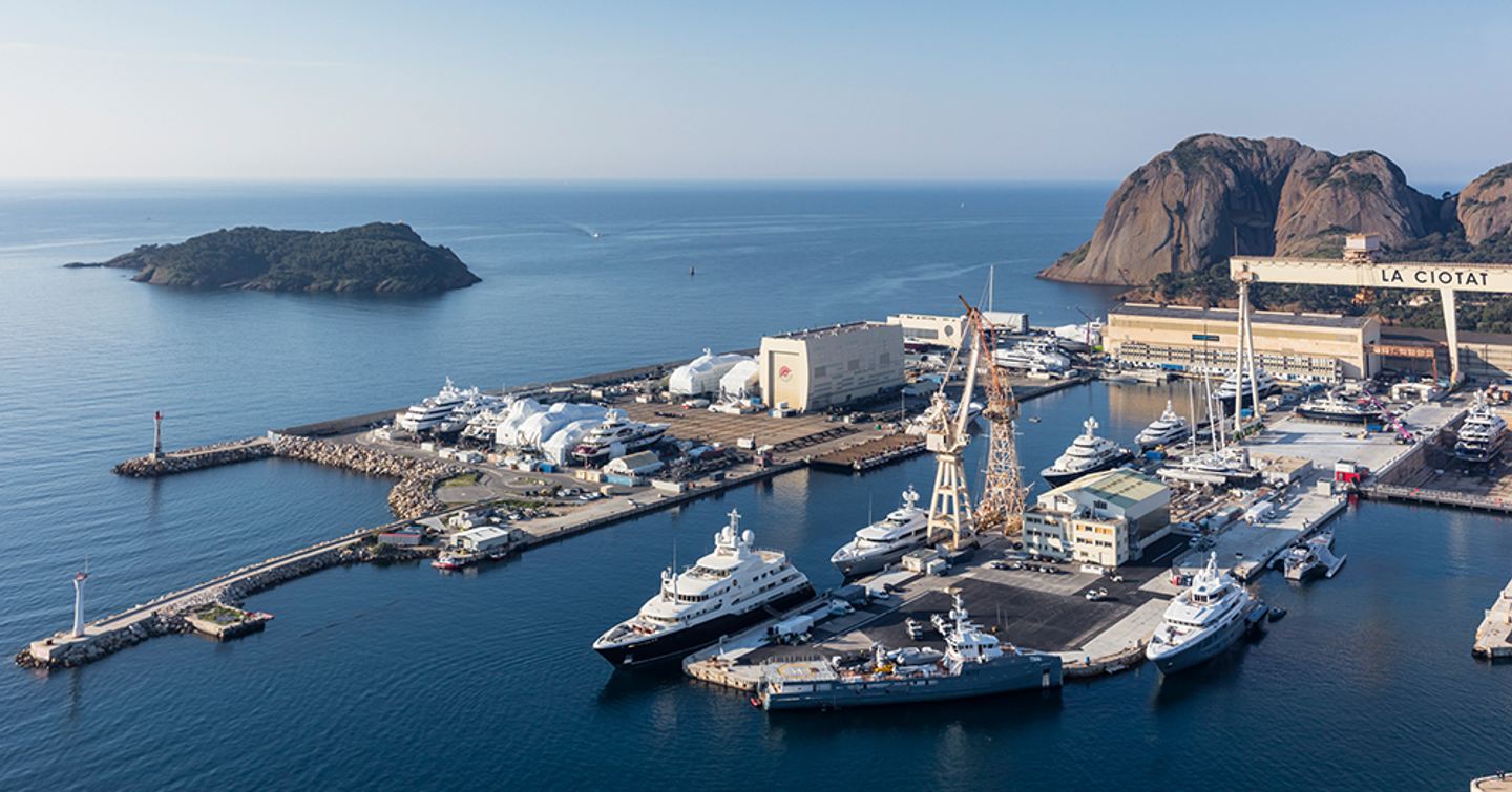 Elevated overview of docks at Monaco Marine Antibes, motor yachts moored, surrounded by sea