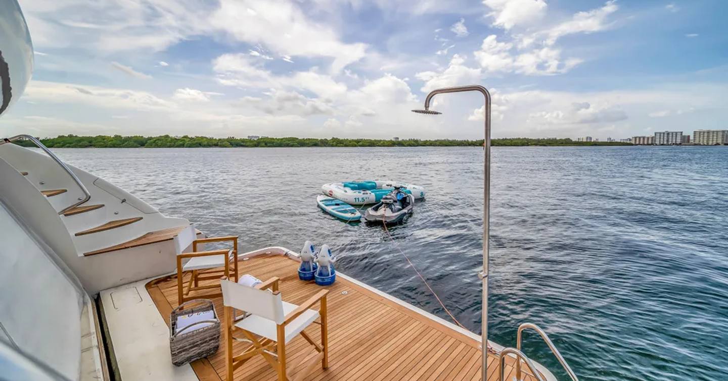 Superyacht Rylax beach platform with deck chairs and outdoor shower