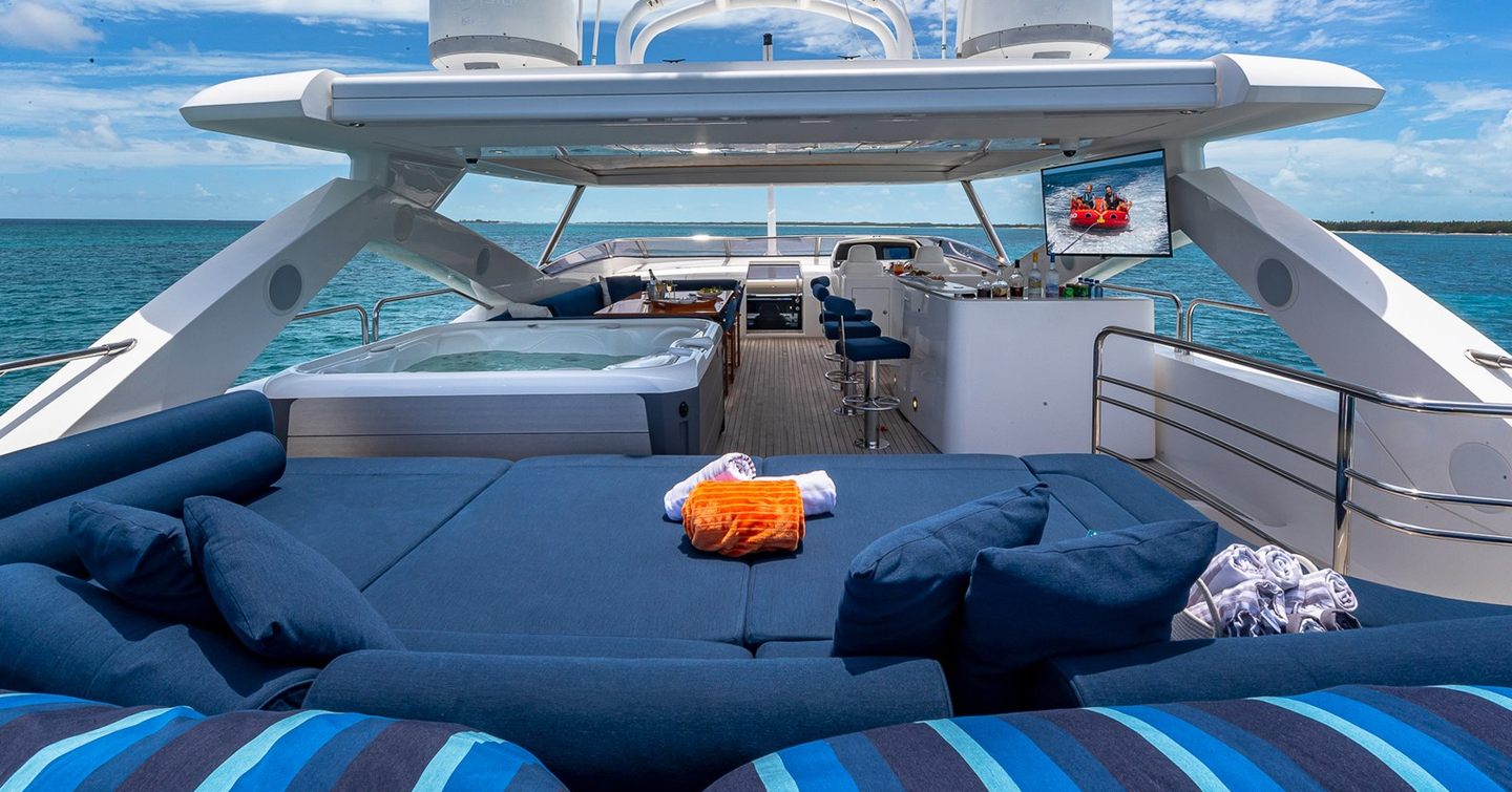 Superyacht Emrys flybridge with sunpads, shaded bar area and jacuzzi