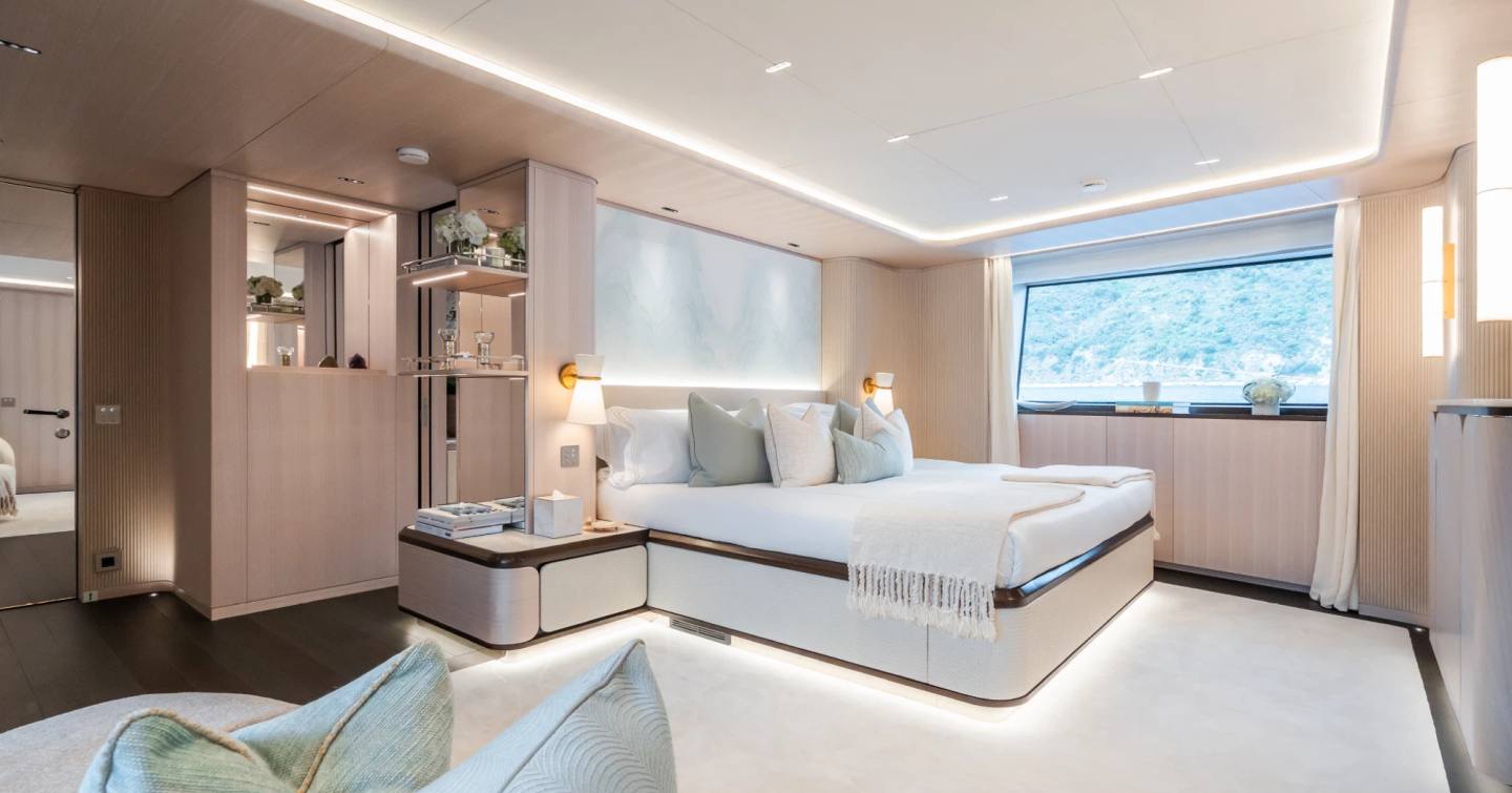 Superyacht M's owners' cabin with spacious bed and expansive windows 