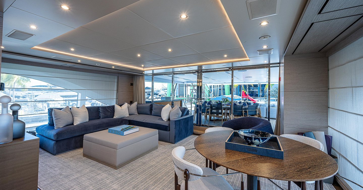 Superyacht Cofina's skylounge with L-shaped seating and circular table