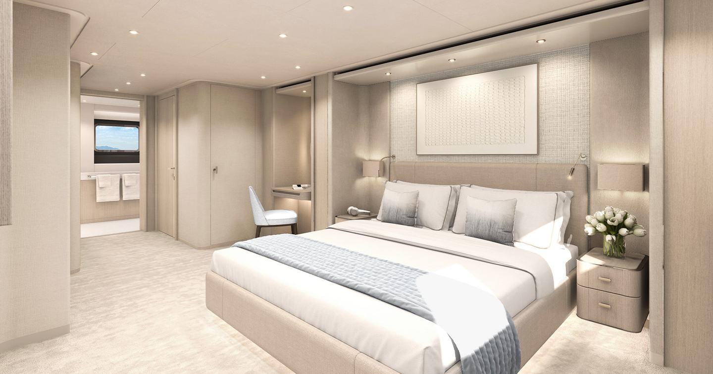 Motor yacht Project Life's owner's cabin with large bed and seating area 