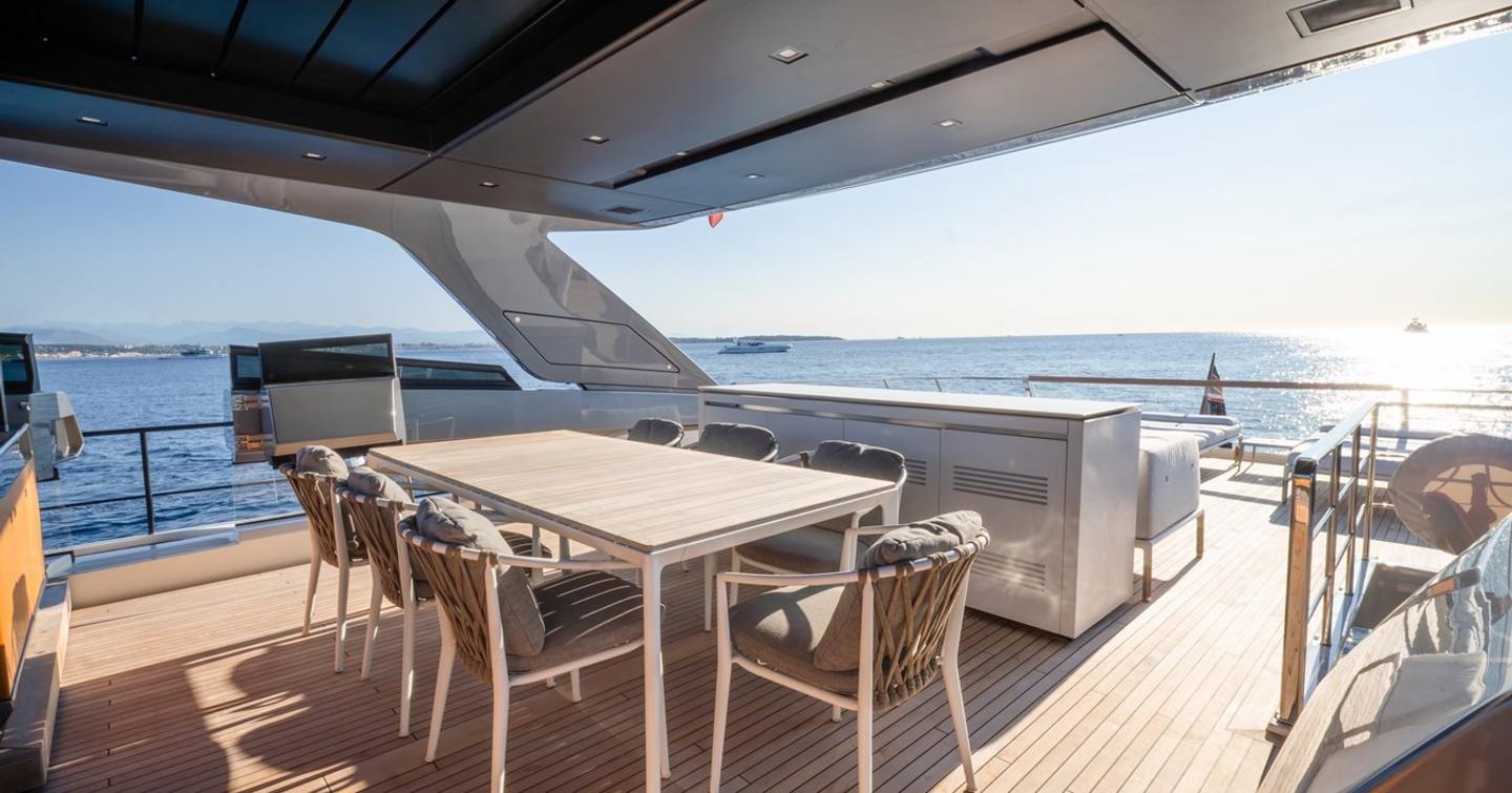 Motor yacht Le Gypsy flybridge with alfresco dining and grey sunpads 