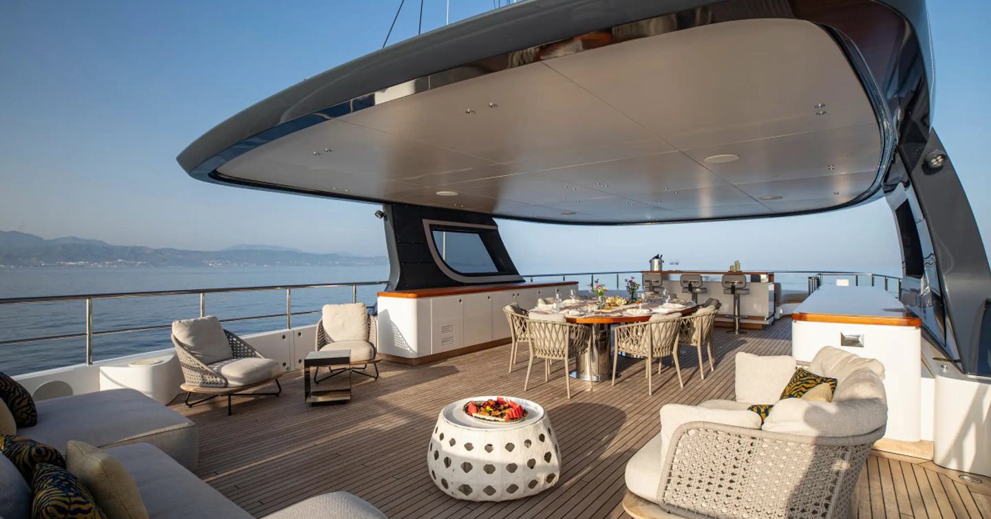 Superyacht Tosun sundeck with shaded alfresco dining and sunpads 
