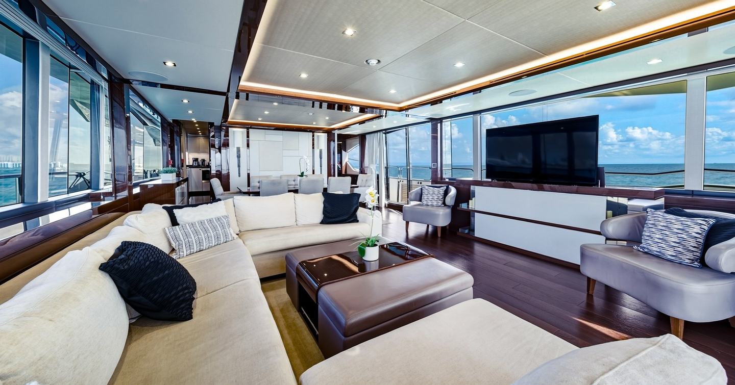 Pura Vida motor yacht main saloon U-shaped white sofa with pop up TV