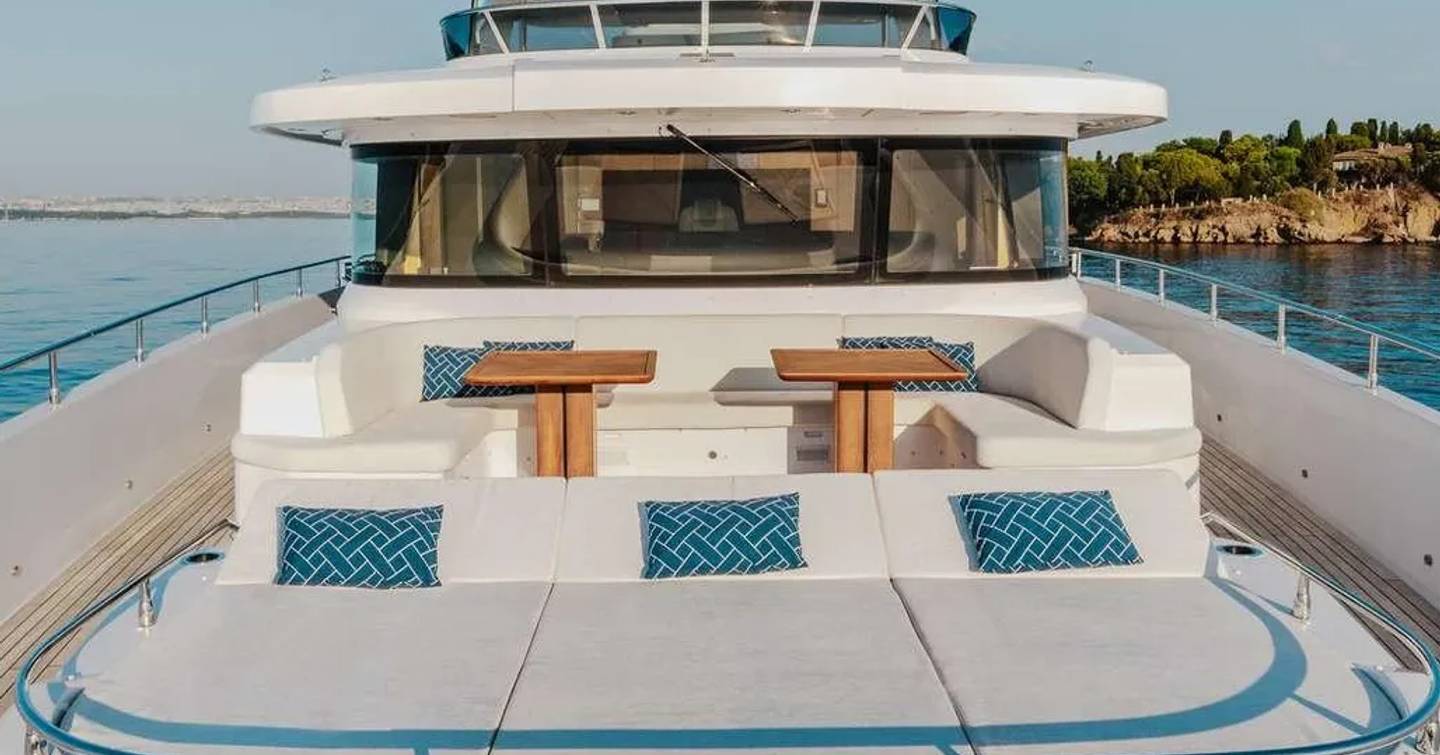 Superyacht Beaute bow with sunpads and wooden tables