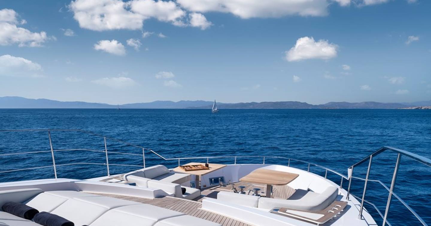 Motor Yacht Spica's foredeck with sunpads and table 