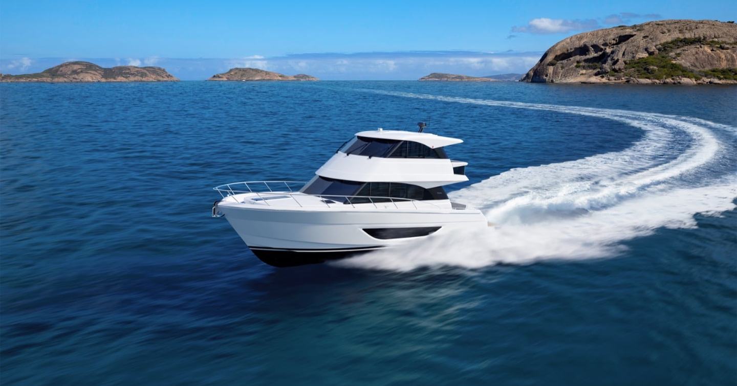 Maritimo M50 enclosed flybridge yacht underway at speed showing hull profile and wake