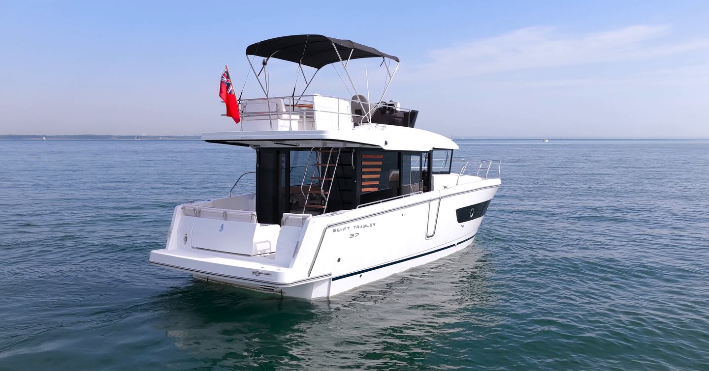 Beneteau Swift Trawler 37 Fly showing cockpit, bathing platform and flybridge access ladder