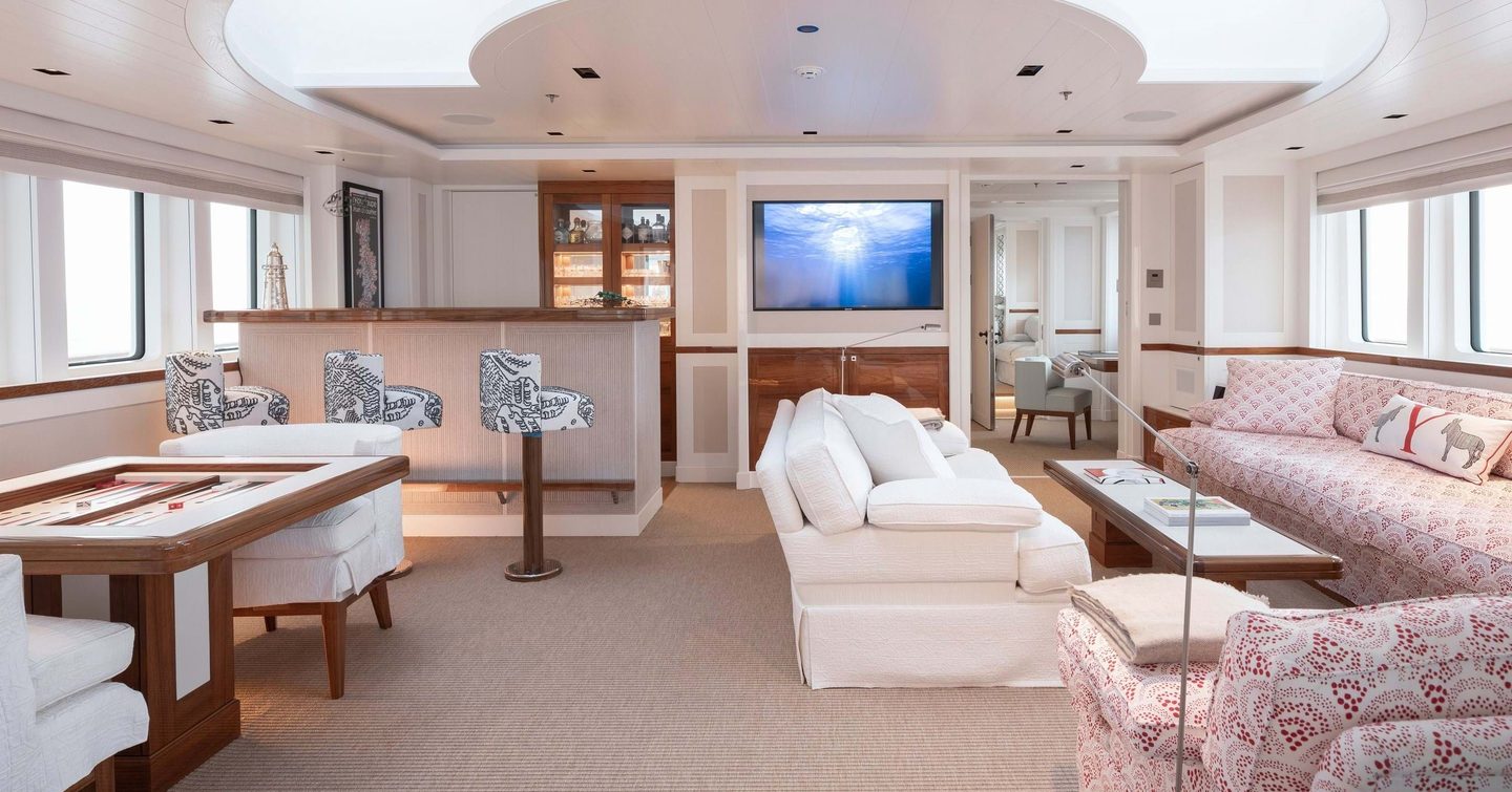 Lightly colored interior with seating, sofas and tables on explorer yacht Blue II