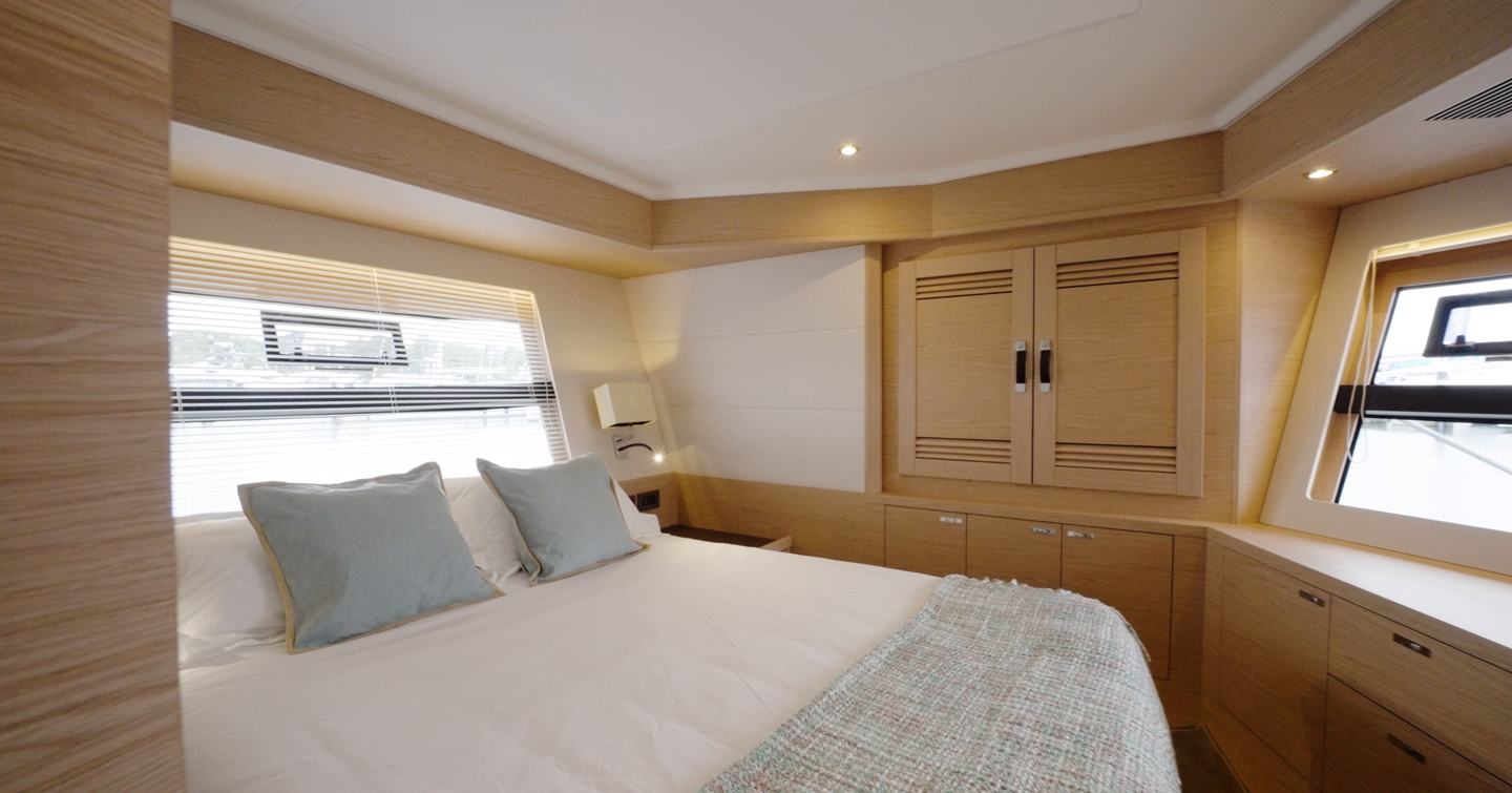 Beneteau Grand Trawler 63 VIP cabin with island double berth, hull windows and generous storage