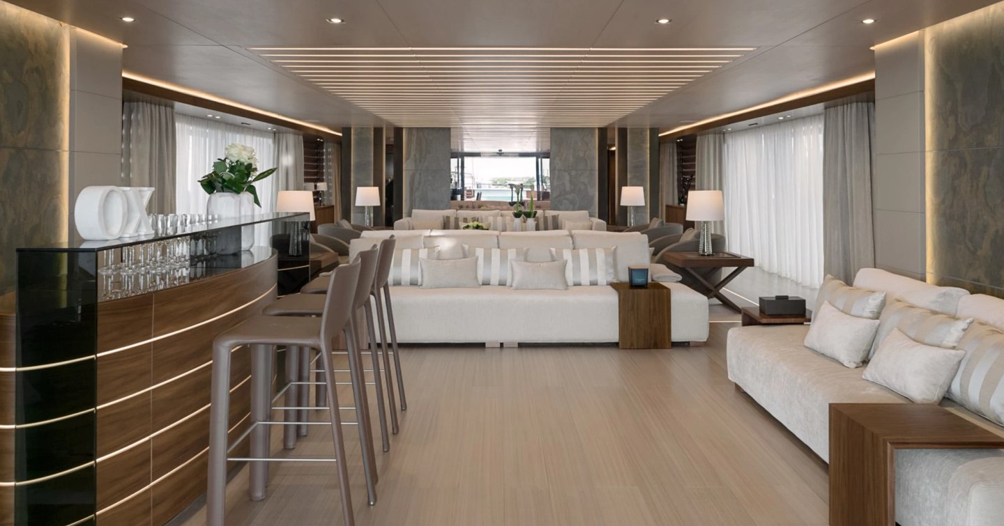 Superyacht Utopia IV main saloon with bar area and white furniture
