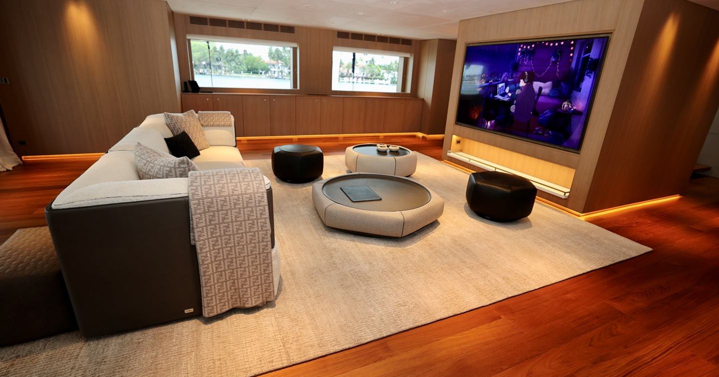 Superyacht Franklie main saloon with mounted TV and circular furnishings 