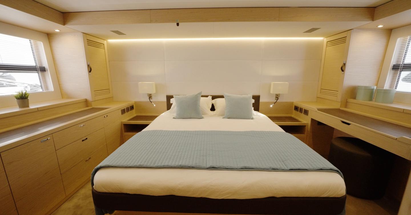 Beneteau Grand Trawler 63 full-beam owner's cabin with island double berth and generous storage