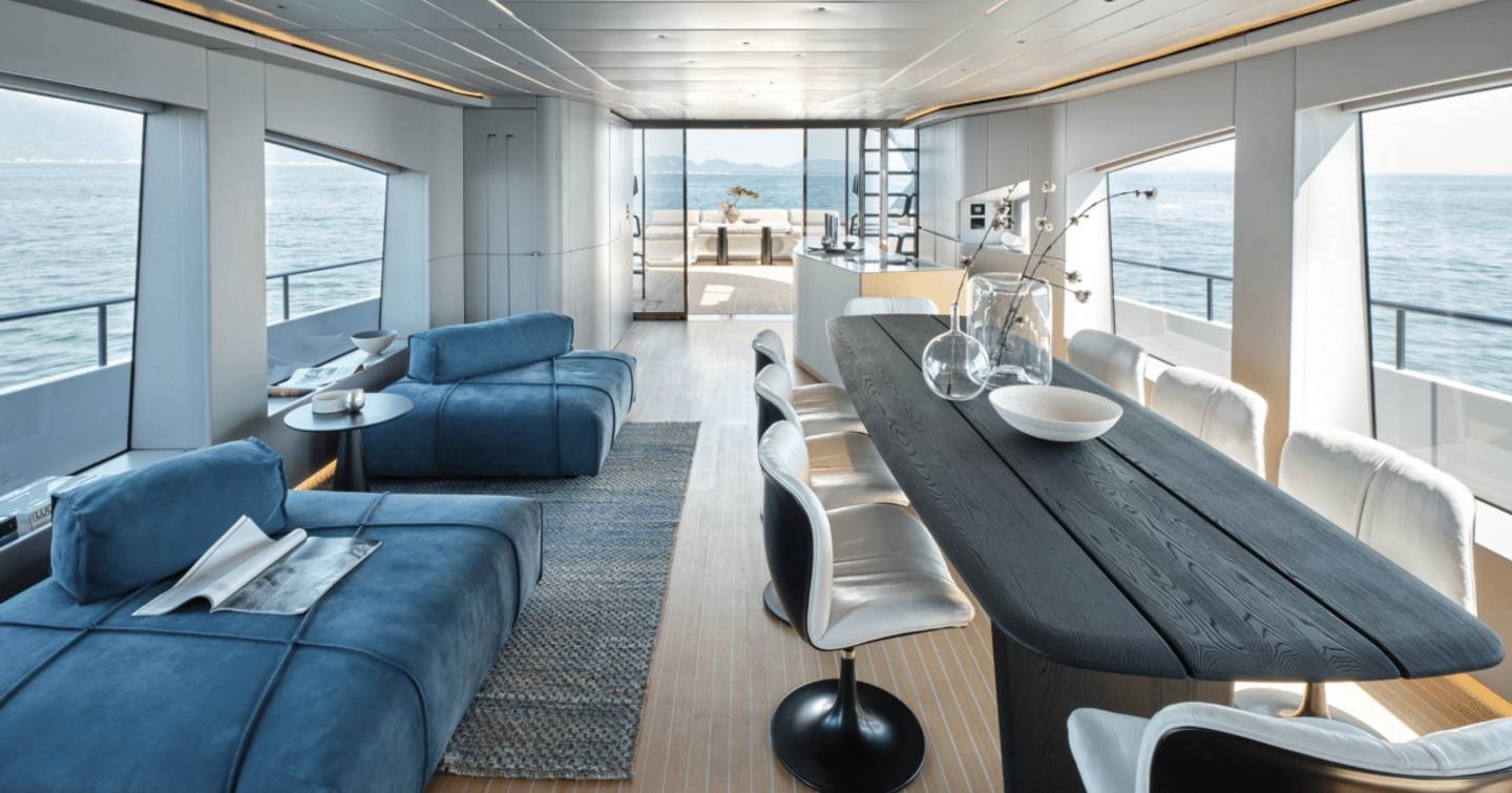 First AB Yachts AB110 hull motor yacht main saloon with dining table and blue seating