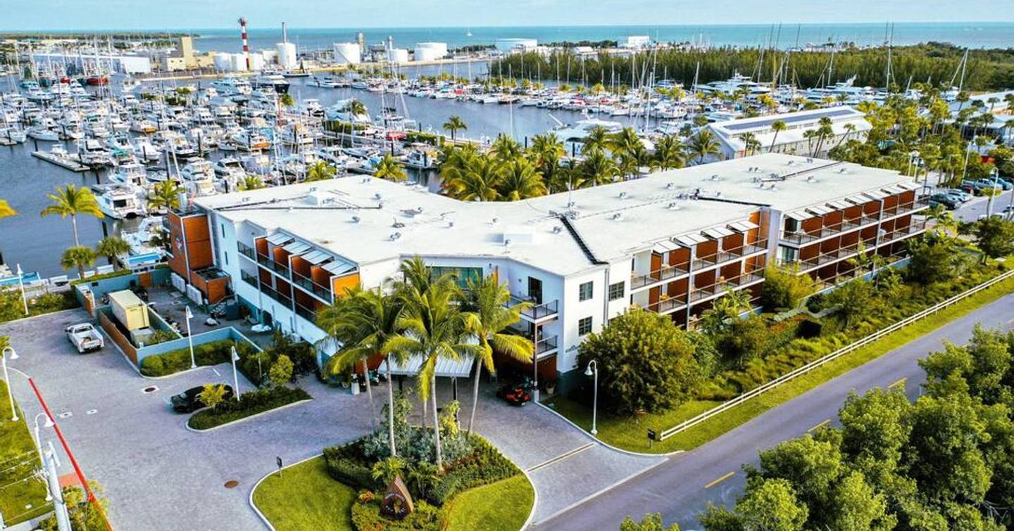 Overview of the Perry Hotel and Marina in Key West, Florida. Hotel in foreground with marina behind, many motoryachts berthed in marina.