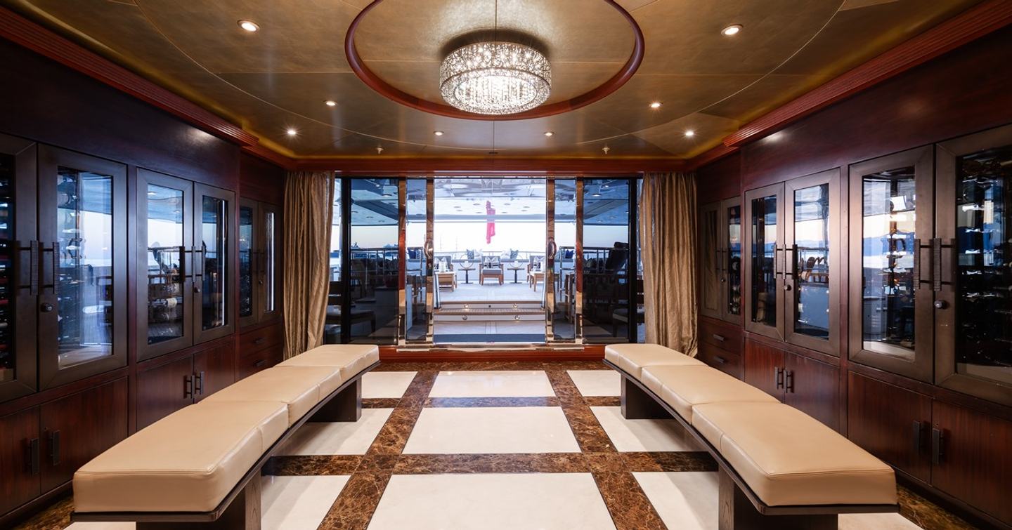 Superyacht Skyfall entrance with wine cellar and circular light fixture 