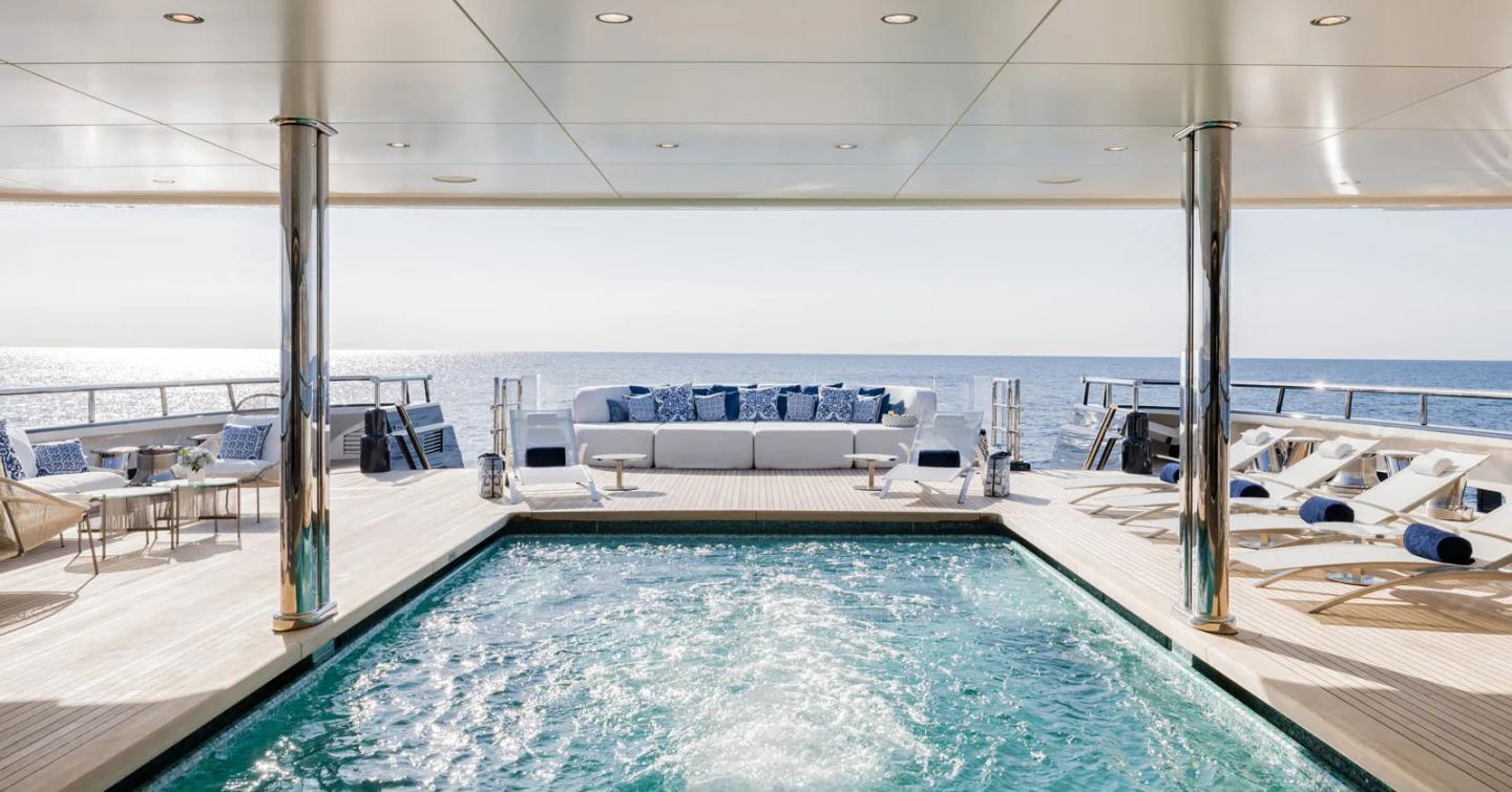 Superyacht Here Comes The Sun recessed main deck pool with surrounding sun loungers 