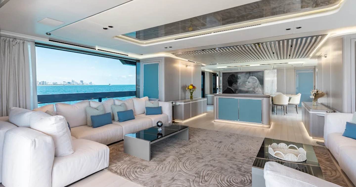Superyacht Half Irish main saloon with neutral palette and L-shaped sofas 