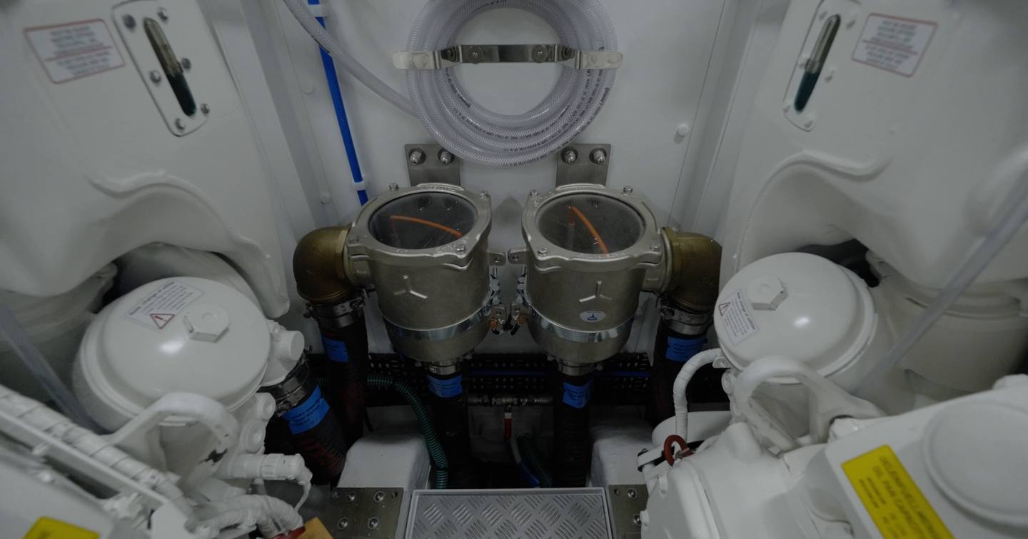 Princess S65 Mk2 engine room with twin seawater strainers between the MAN V12 engines
