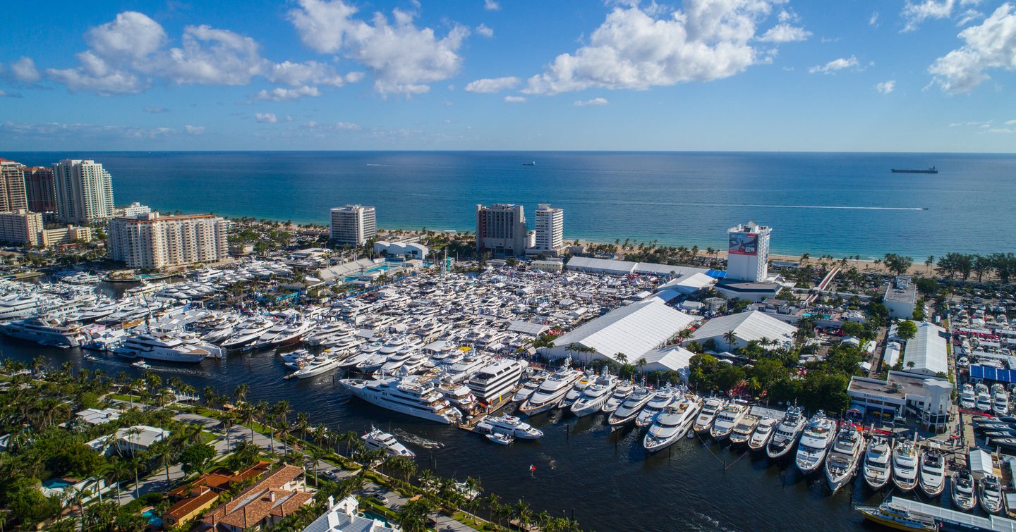 Elevated view of FLIBS, hundreds of yachts at anchor surrounded by Fort Lauderdale infrastructure and the sea in background