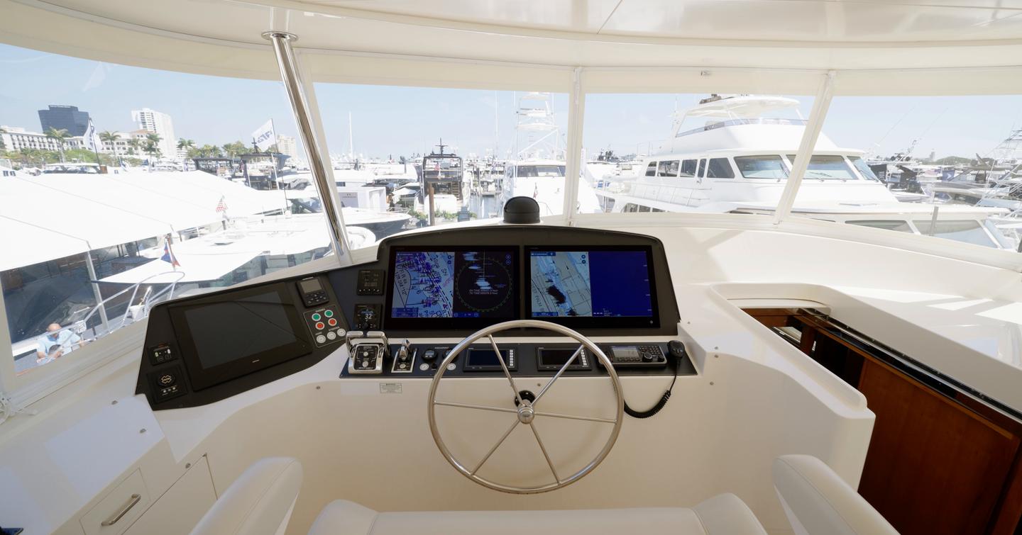 Fleming 85 flybridge helm station with panoramic visibility and twin navigation displays