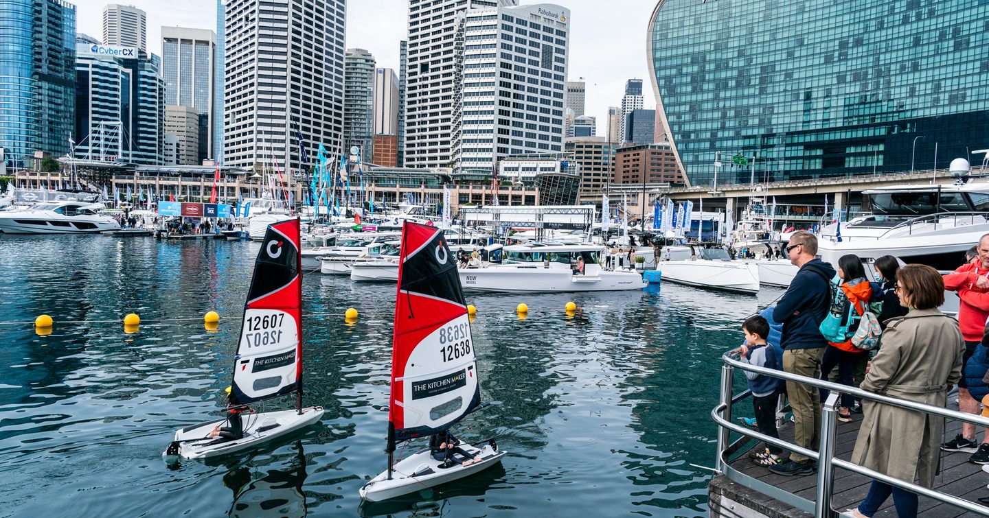 Small sail boats at the 2024 Sydney International On-Water Boat Show with Sydney skyline behind