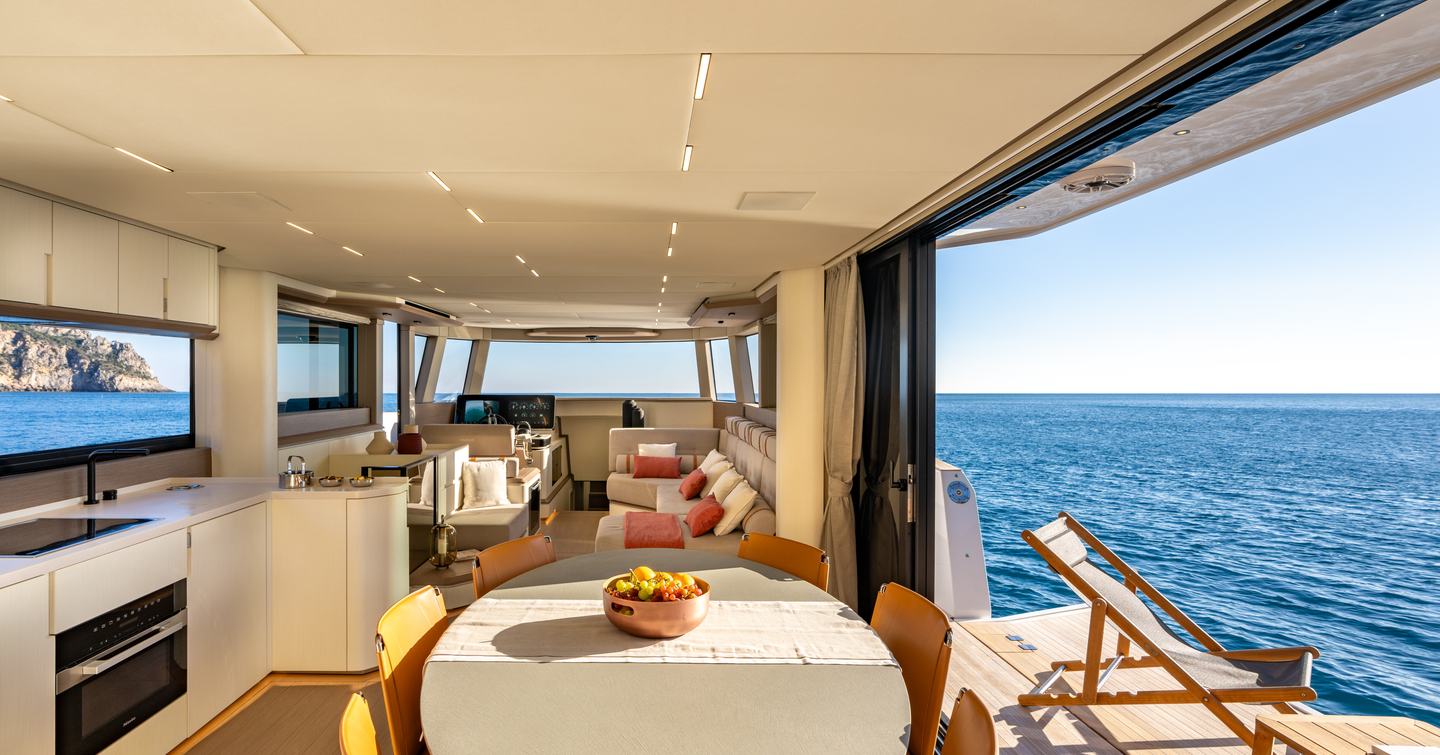 Pardo E72's main saloon with fold out balcony and circular dining table 