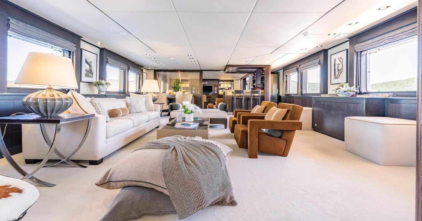 Superyacht Victory's main saloon with white sofa and grey accents