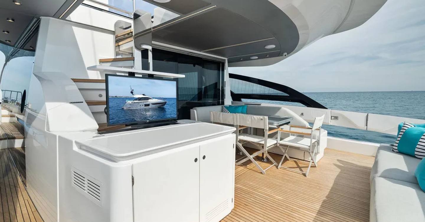 Motor yacht Ocean's Se7en's aft dining area and pop up TV